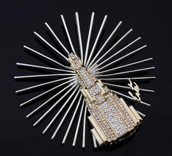 An Erté silver, 14ct gold and diamond set Manhattan brooch, 2.25in.